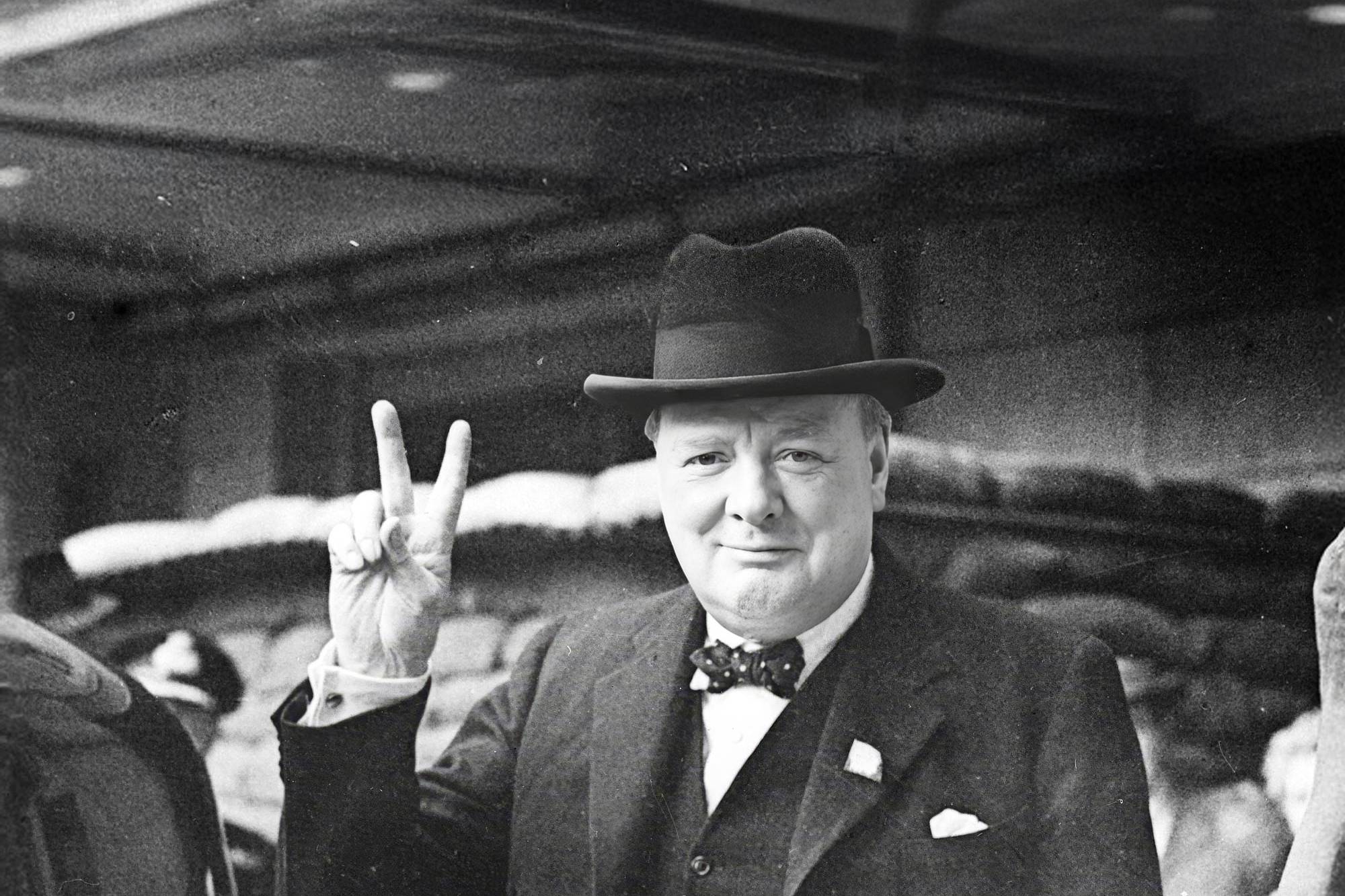 Image of Winston Churchill making the V for Victory gesture in 1940s London