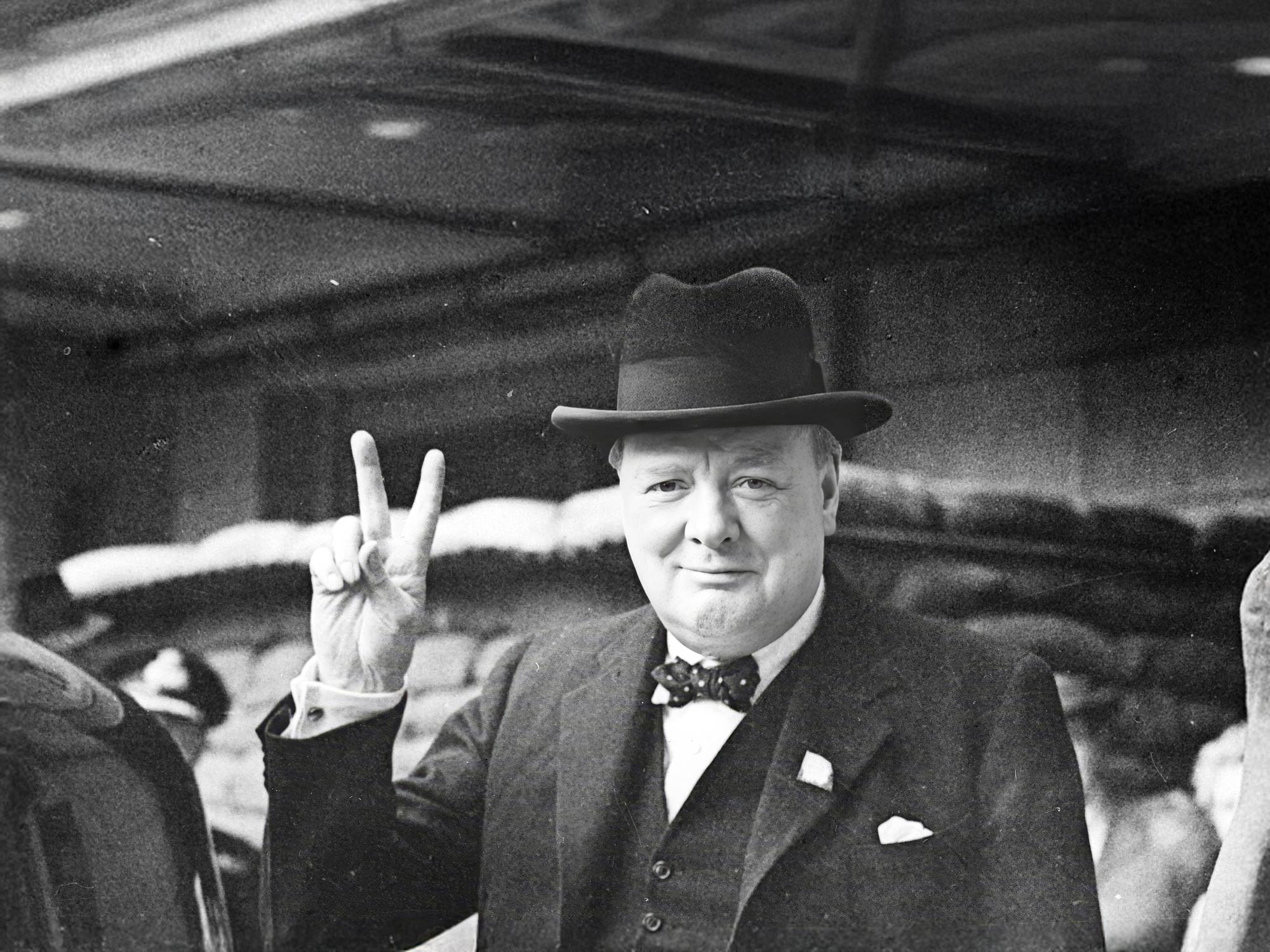 Image of Winston Churchill making the V for Victory gesture in 1940s London